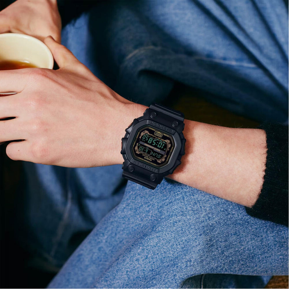 Black digital watch on wrist with rugged case and chunky plastic strap