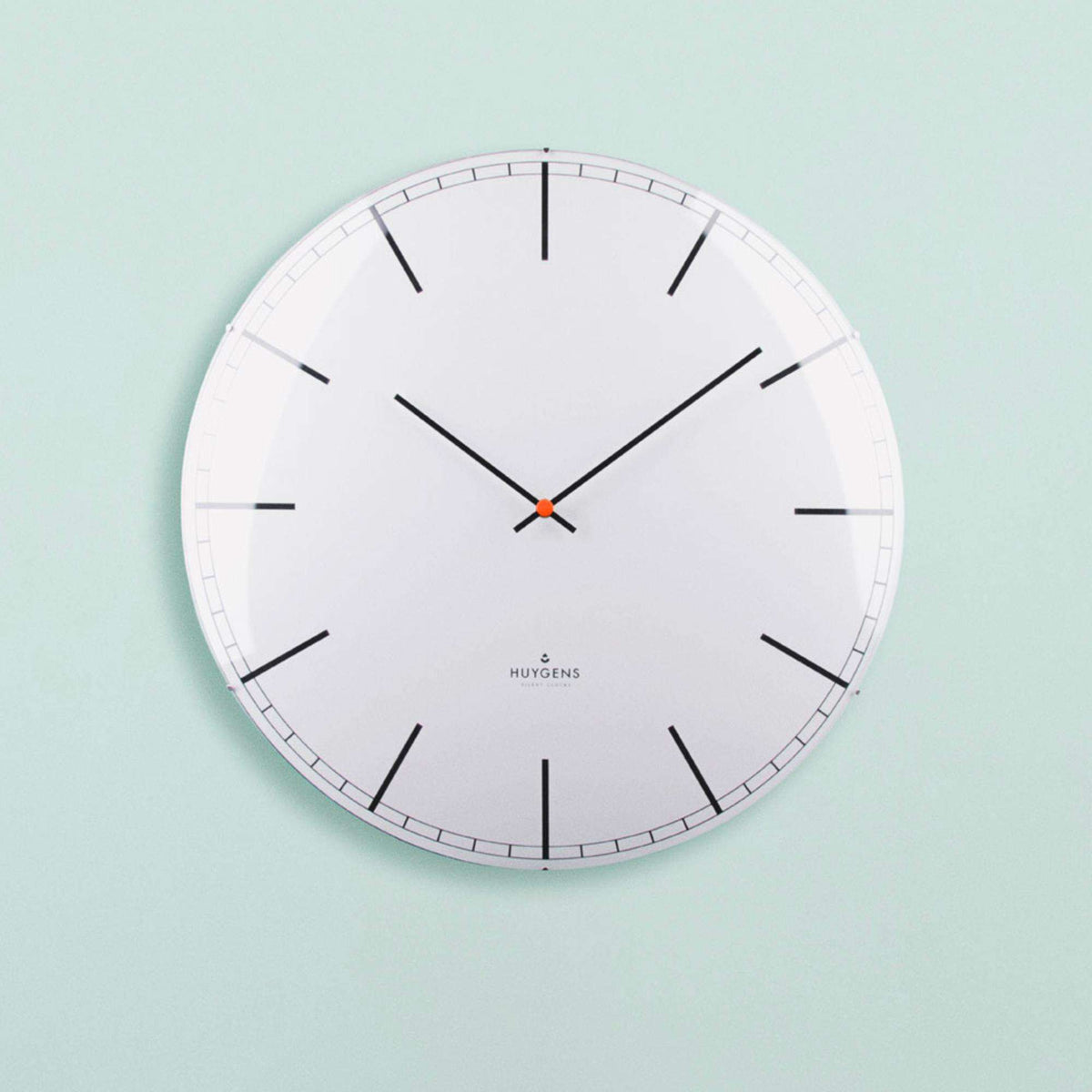 White wall clock with black hands and minute track around a clean white dial