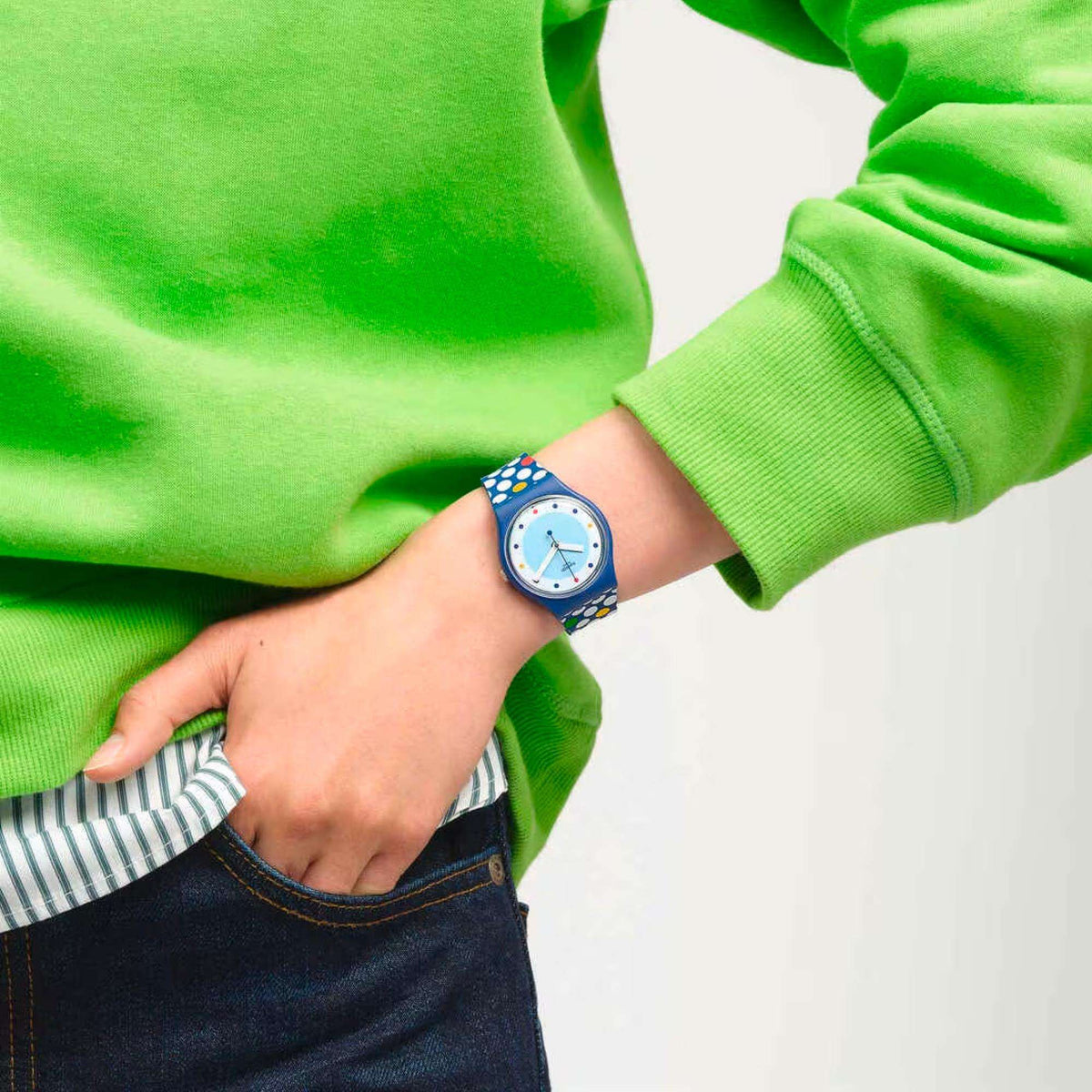 Unisex quartz watch on wrist, blue polka dot silicone strap and light blue dial