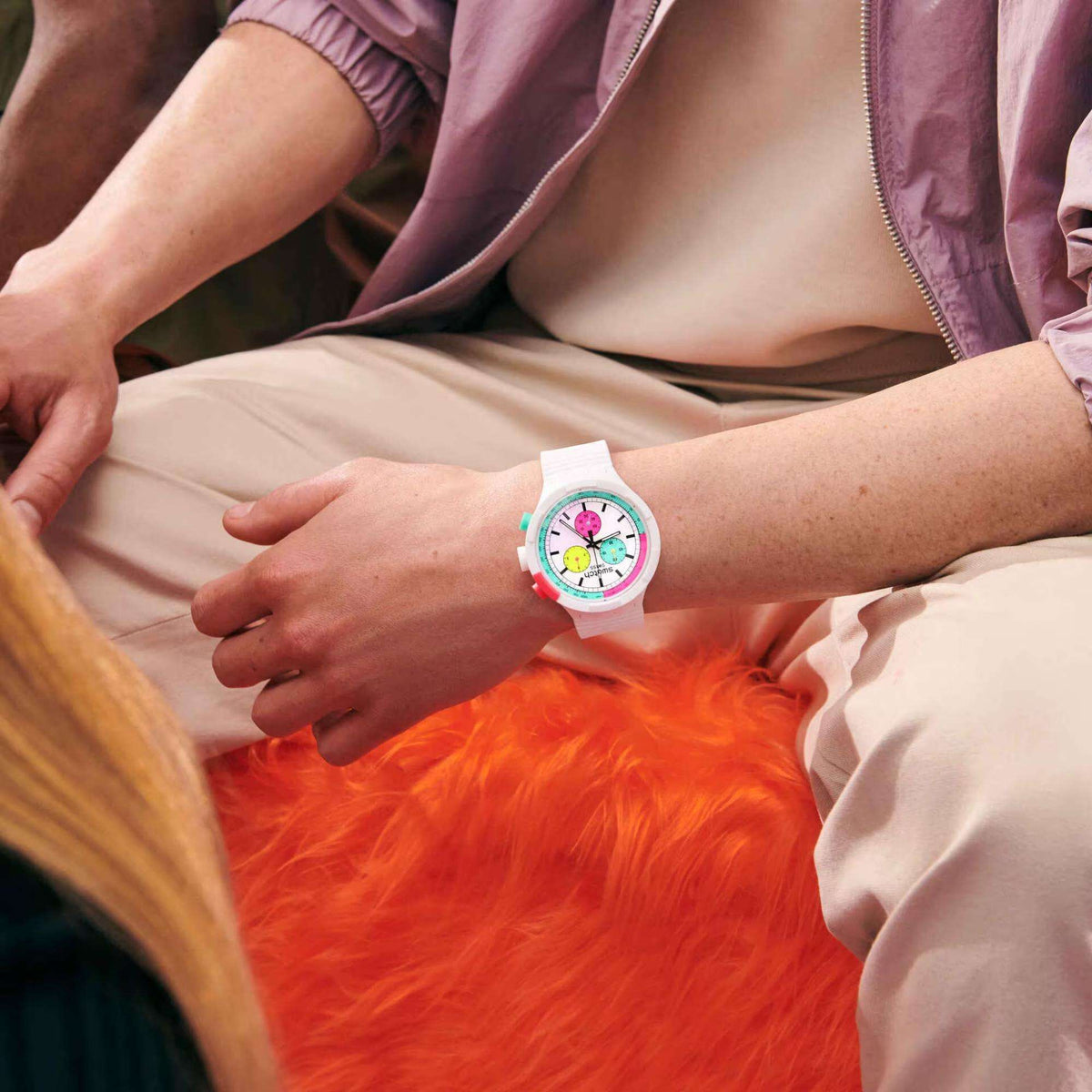 Ladies quartz watch on wrist: white strap and multicolor dial with round push buttons