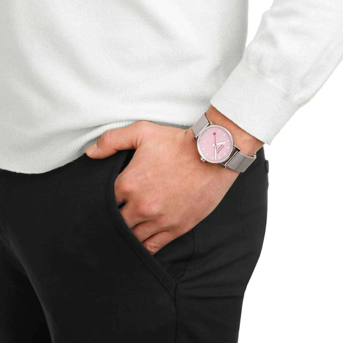 Ladies quartz watch with pink dial on a silver mesh steel bracelet, worn on wrist