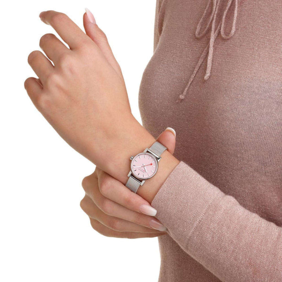 Women's steel mesh watch with pink dial and silver bezel on wrist