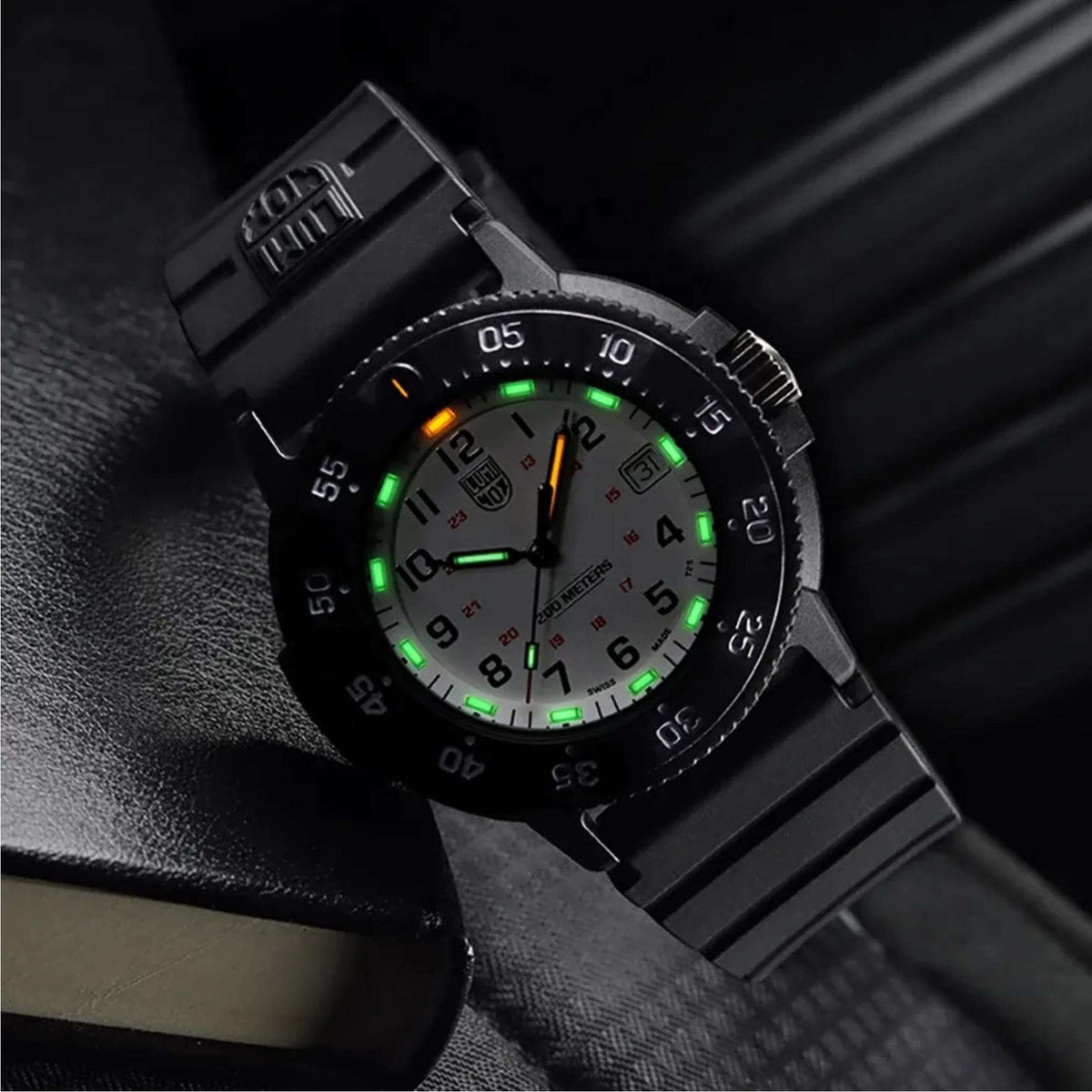 Men's dive watch with black dial and luminous hands, orange and green accents