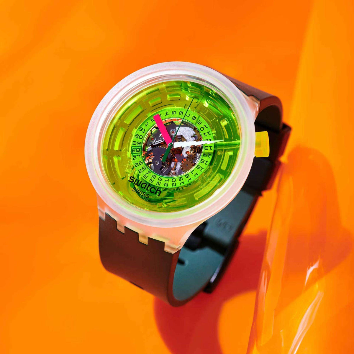 Swatch neon quartz watch with neon green dial, clear bezel, and dark green strap