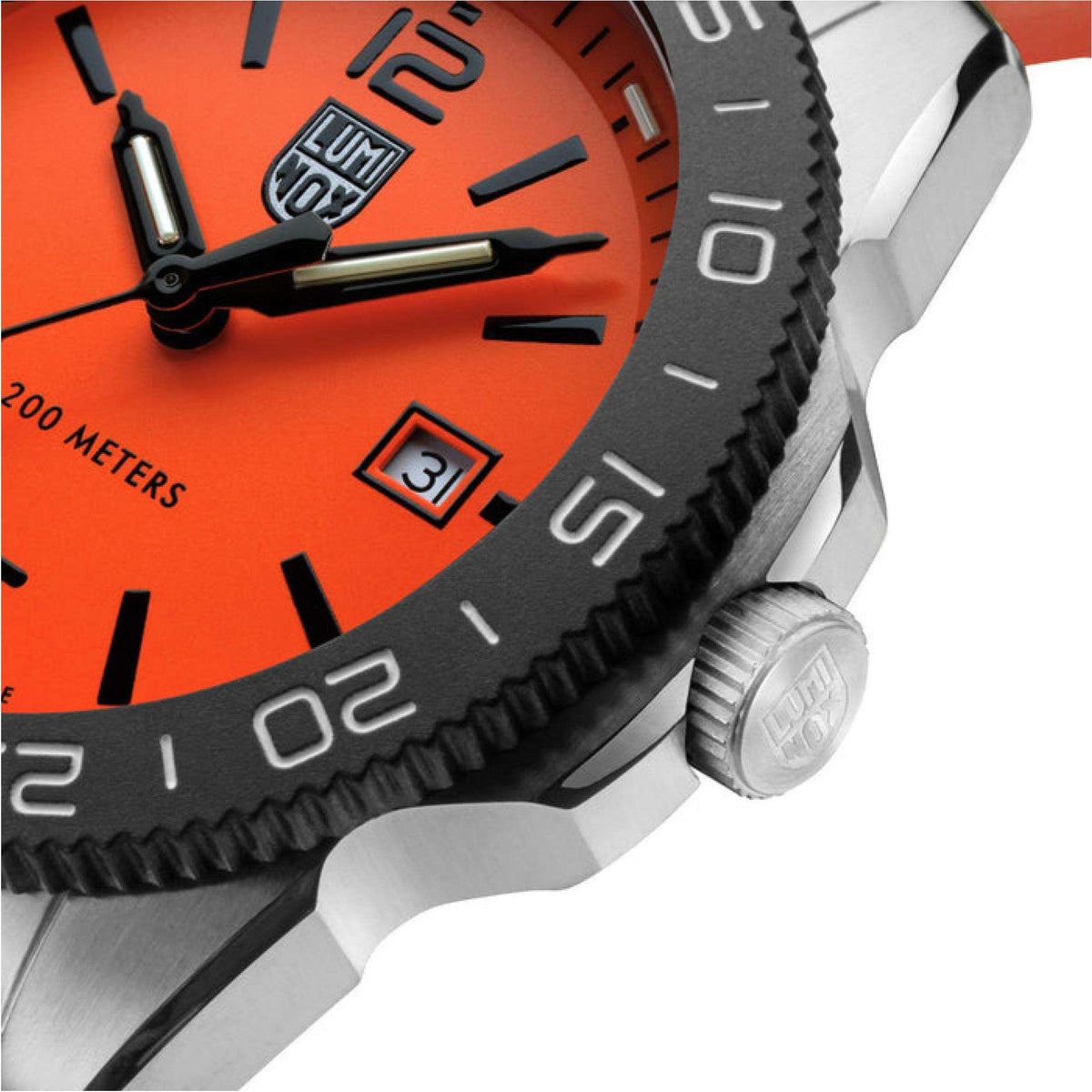 Close-up diver watch bezel with raised markers, orange dial, and crown-side case detail