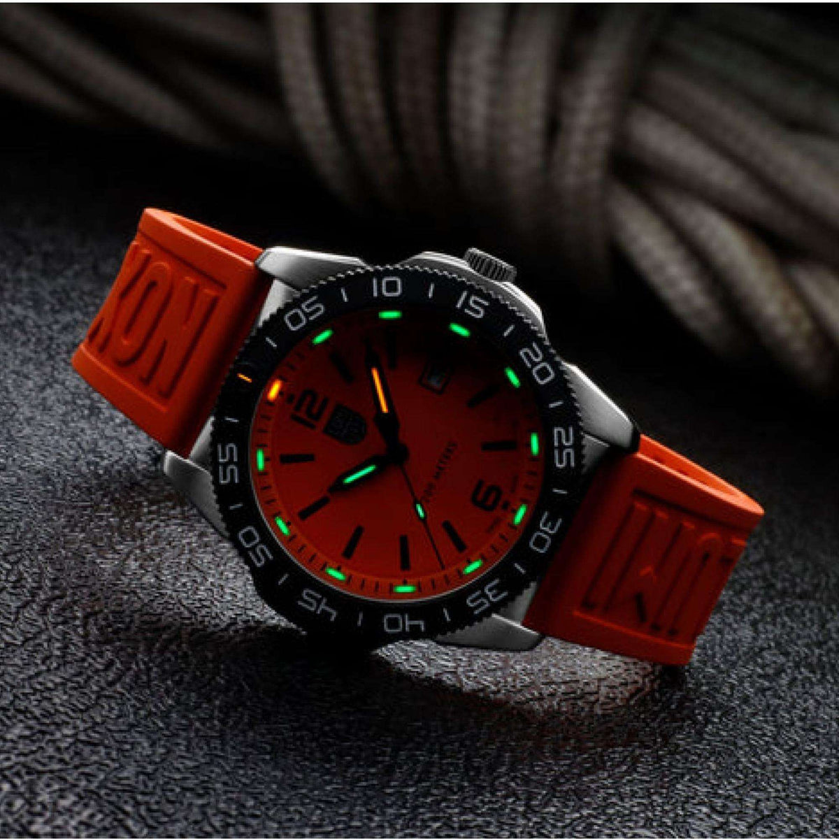 Orange dial diver watch with green luminous hands, black bezel, and orange rubber strap