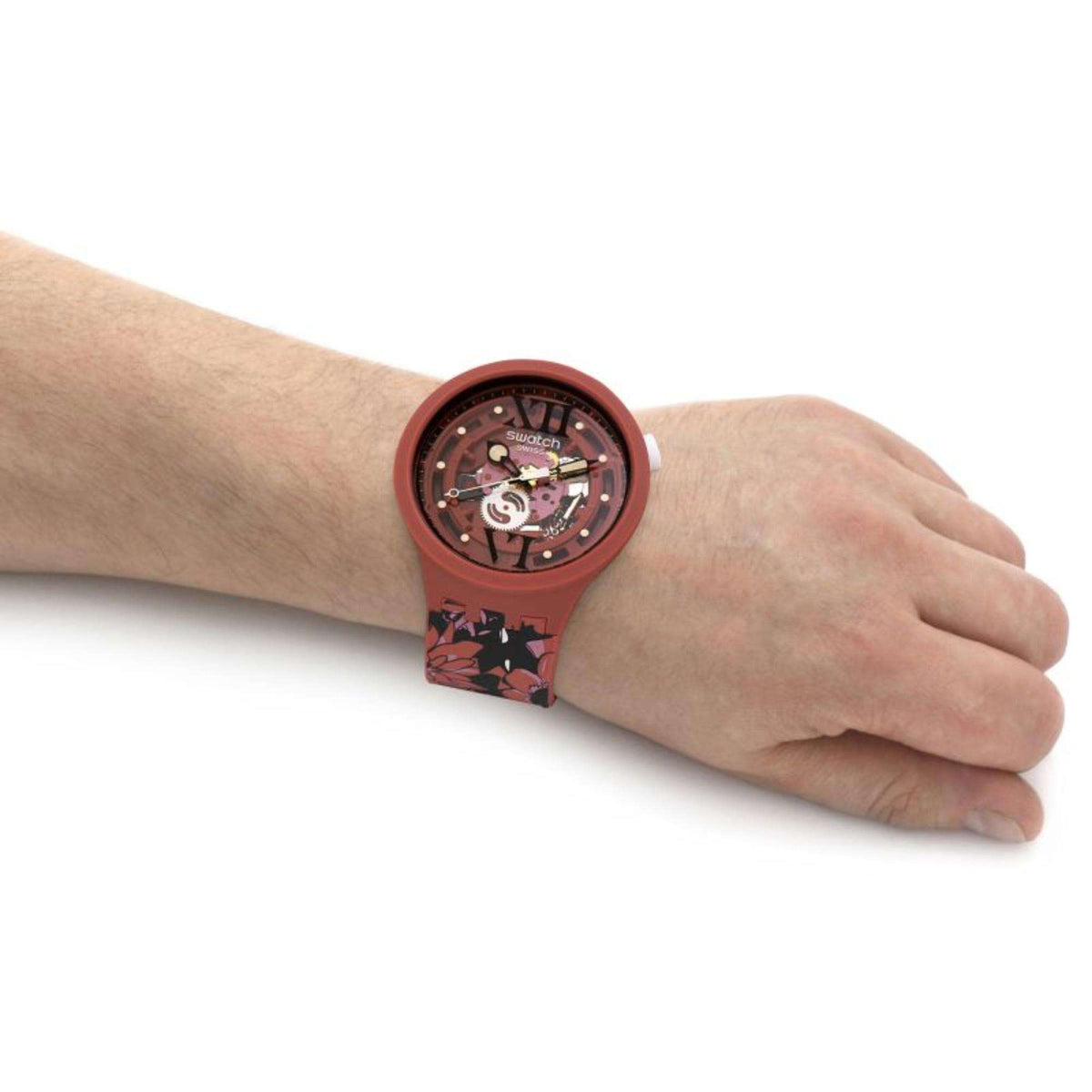 Brown Swatch watch worn on wrist, round dial with floral strap band