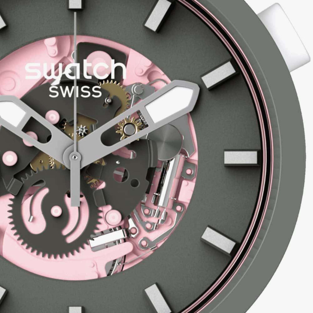 Women’s Swatch skeleton-dial watch close-up: dark case, pink gears, silver hands