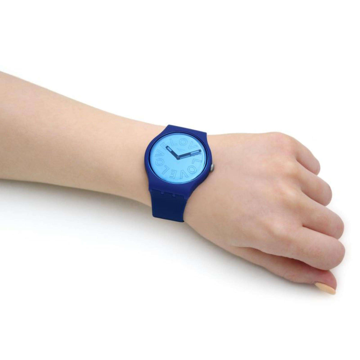 Men's Swatch wristwatch close-up on wrist with blue dial and silicone band