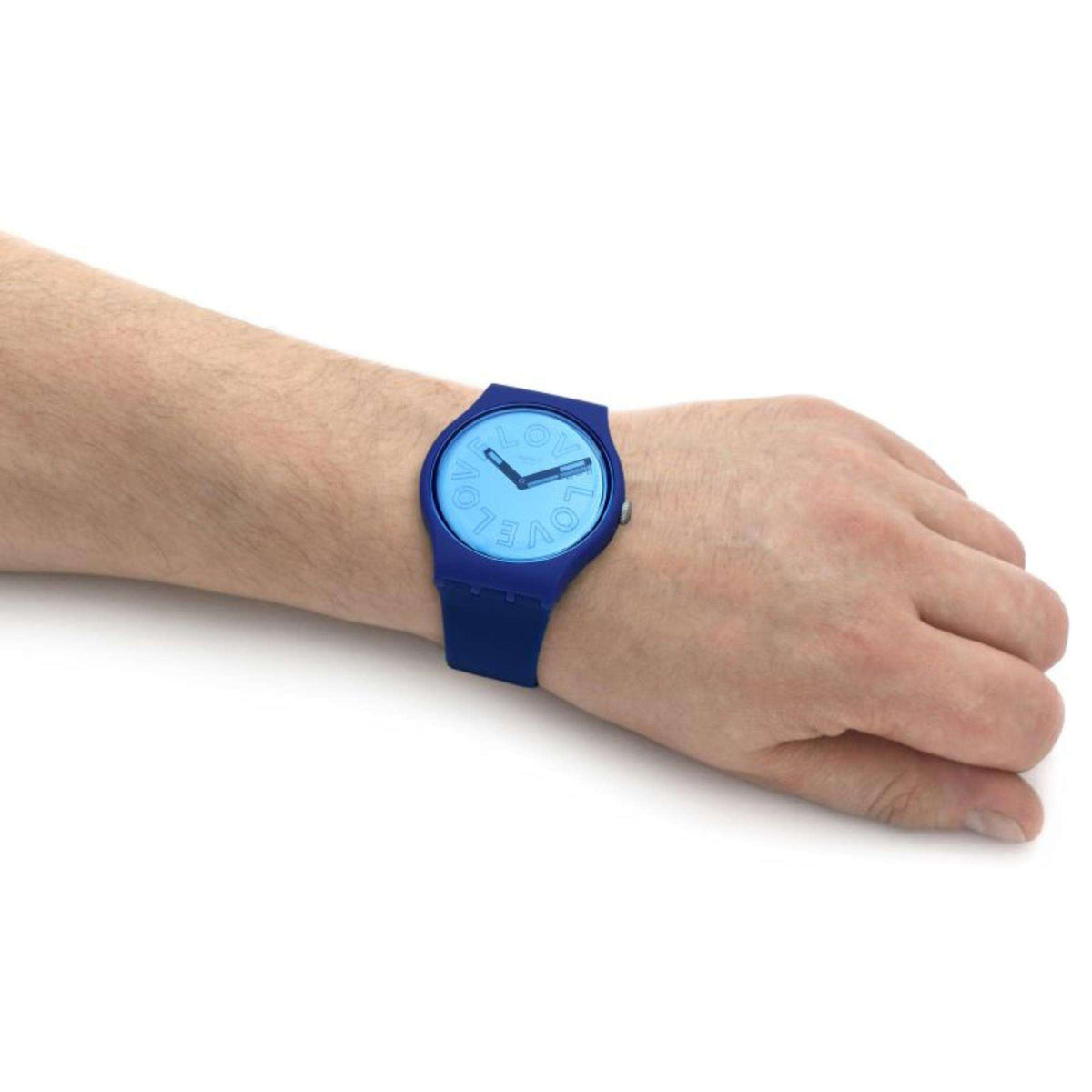 Men's Swatch wristwatch close-up showing blue dial and purple-blue strap