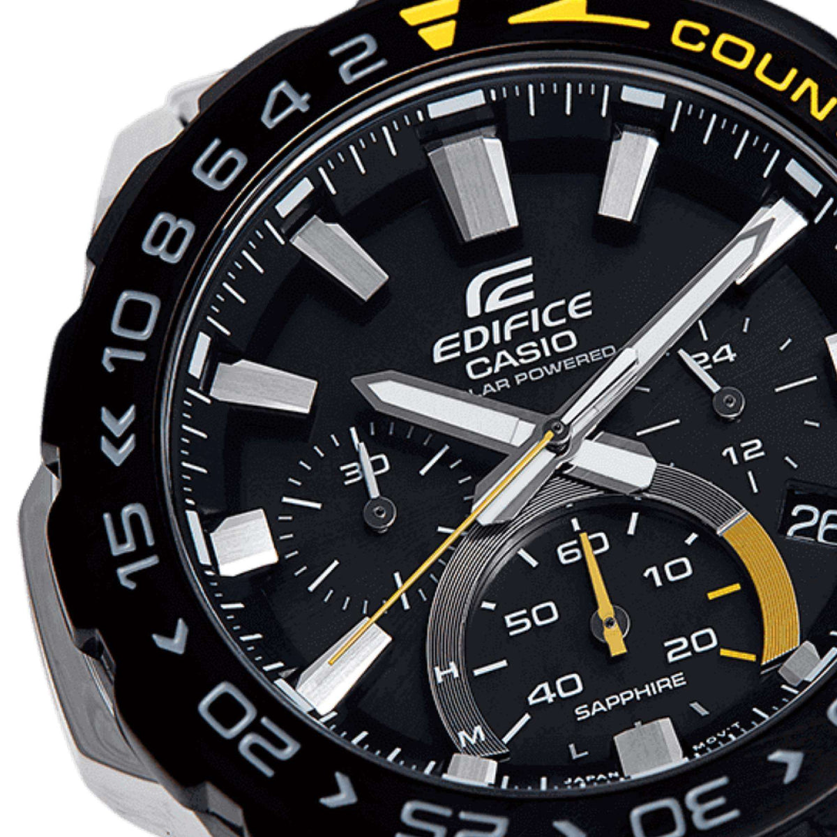 Close-up of men's black chronograph dial with yellow hands and silver hour markers.