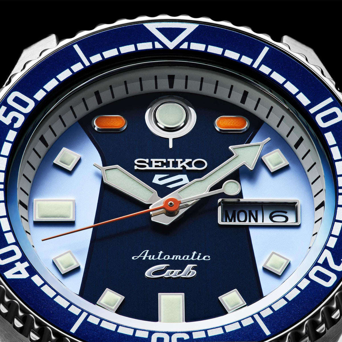 Close-up of blue dial diver watch with date window and knurled bezel