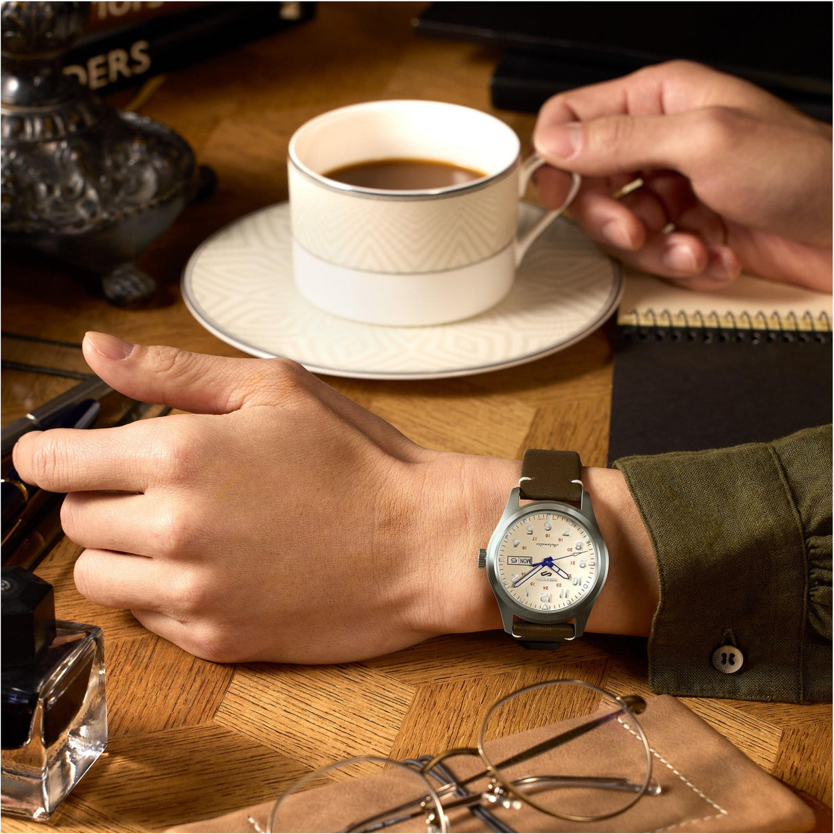 Seiko 5 Sports SRPK41K1 brown leather strap on a wrist next to a coffee cup lifestyle view