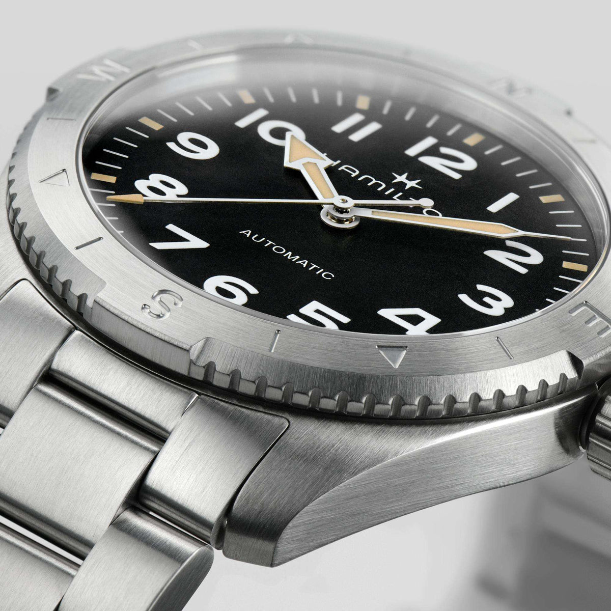 Hamilton H70225130 black textured dial with Arabic numerals and compass bezel close-up