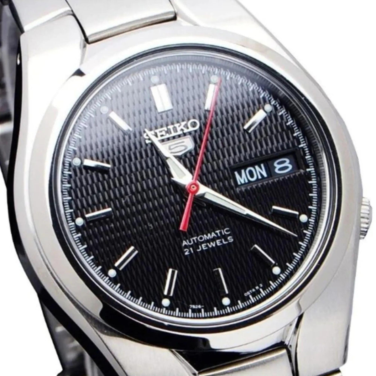 Seiko 5 Automatic SNK607K1 close-up view showing textured black dial detail and steel bezel