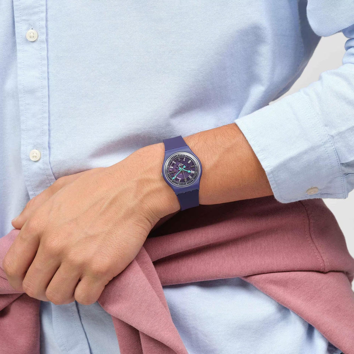 Purple silicone strap watch worn on wrist with purple dial and green hands