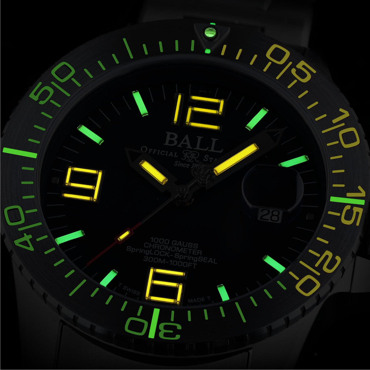 Close-up of black watch dial with glowing green and yellow luminous hands and hour markers