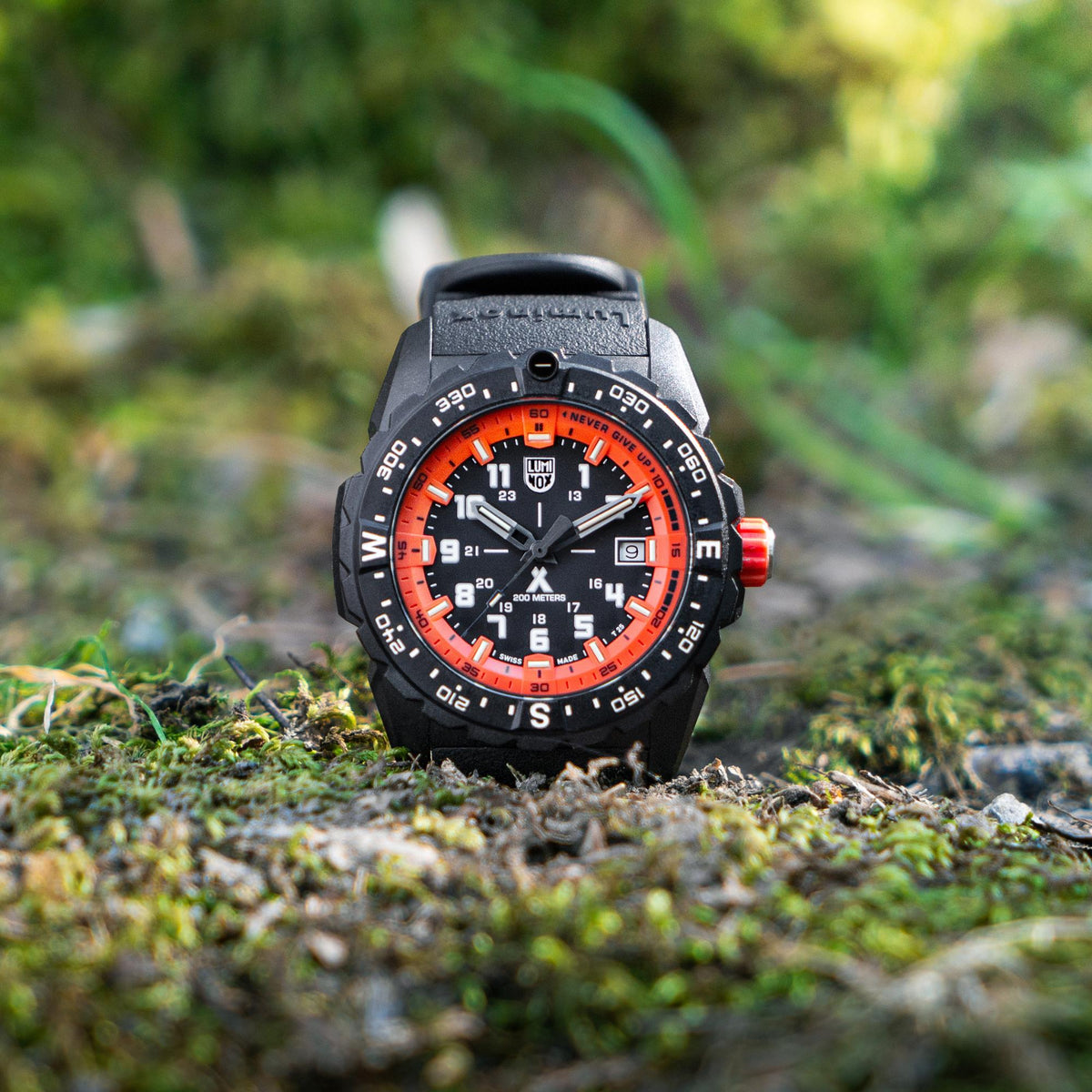 Outdoor view: black sports watch with orange inner dial ring and luminous numerals