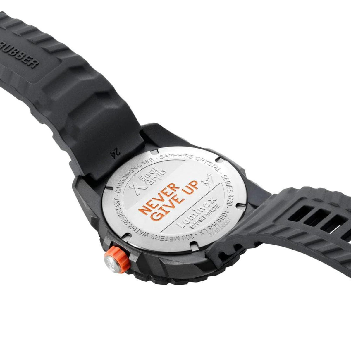 Back of black rubber dive watch with “Never Give Up” caseback and orange screw button.