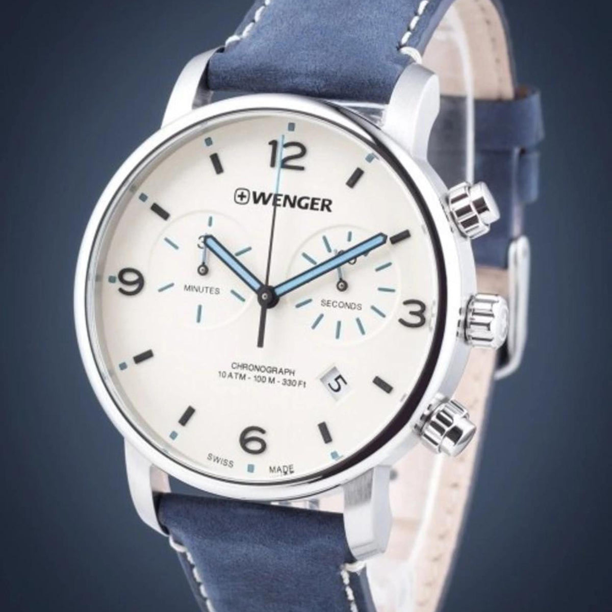 Men's chronograph watch close-up: cream dial, blue subdials, blue leather strap, silver bezel