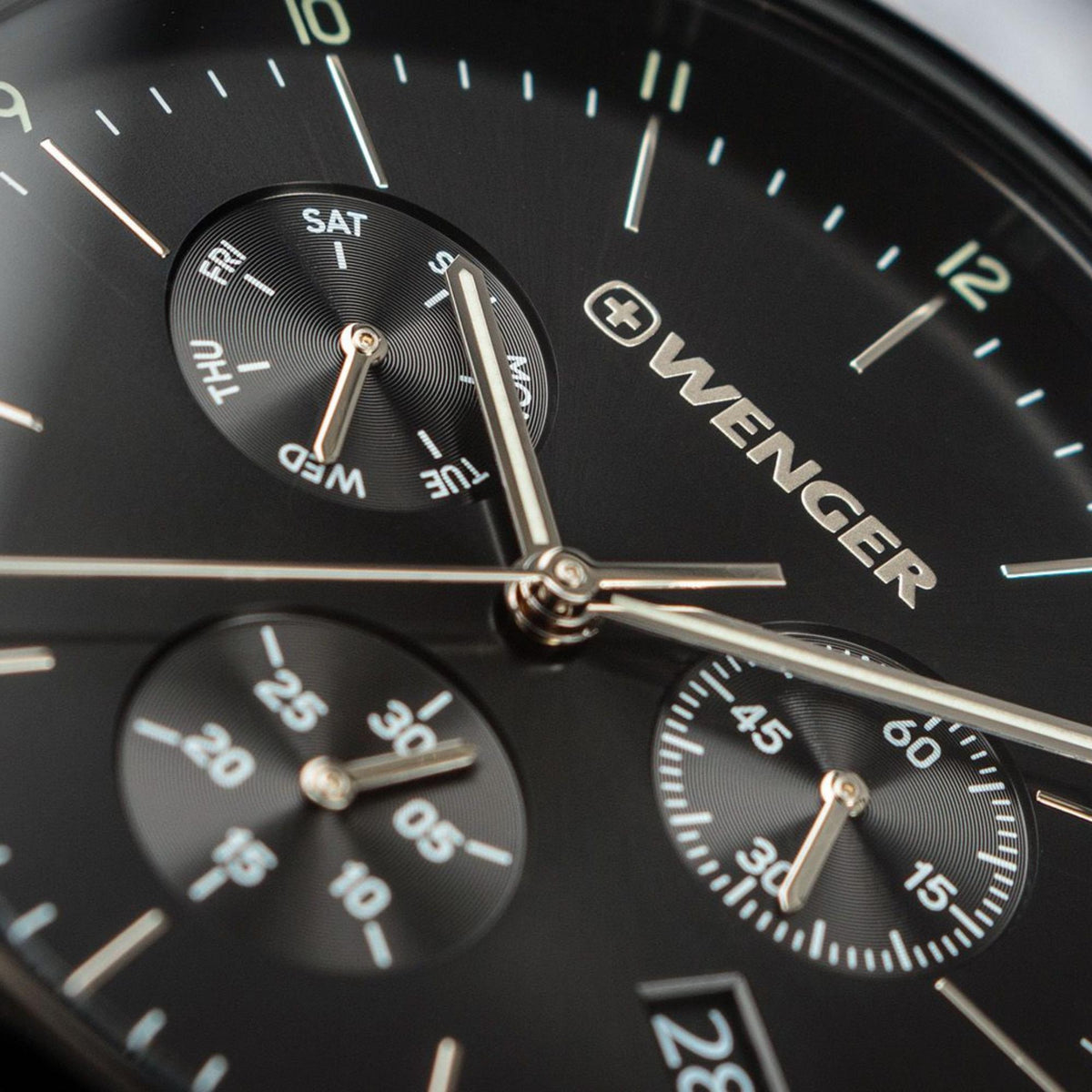 Men's chronograph watch dial close-up with WENGER logo and multiple subdials.