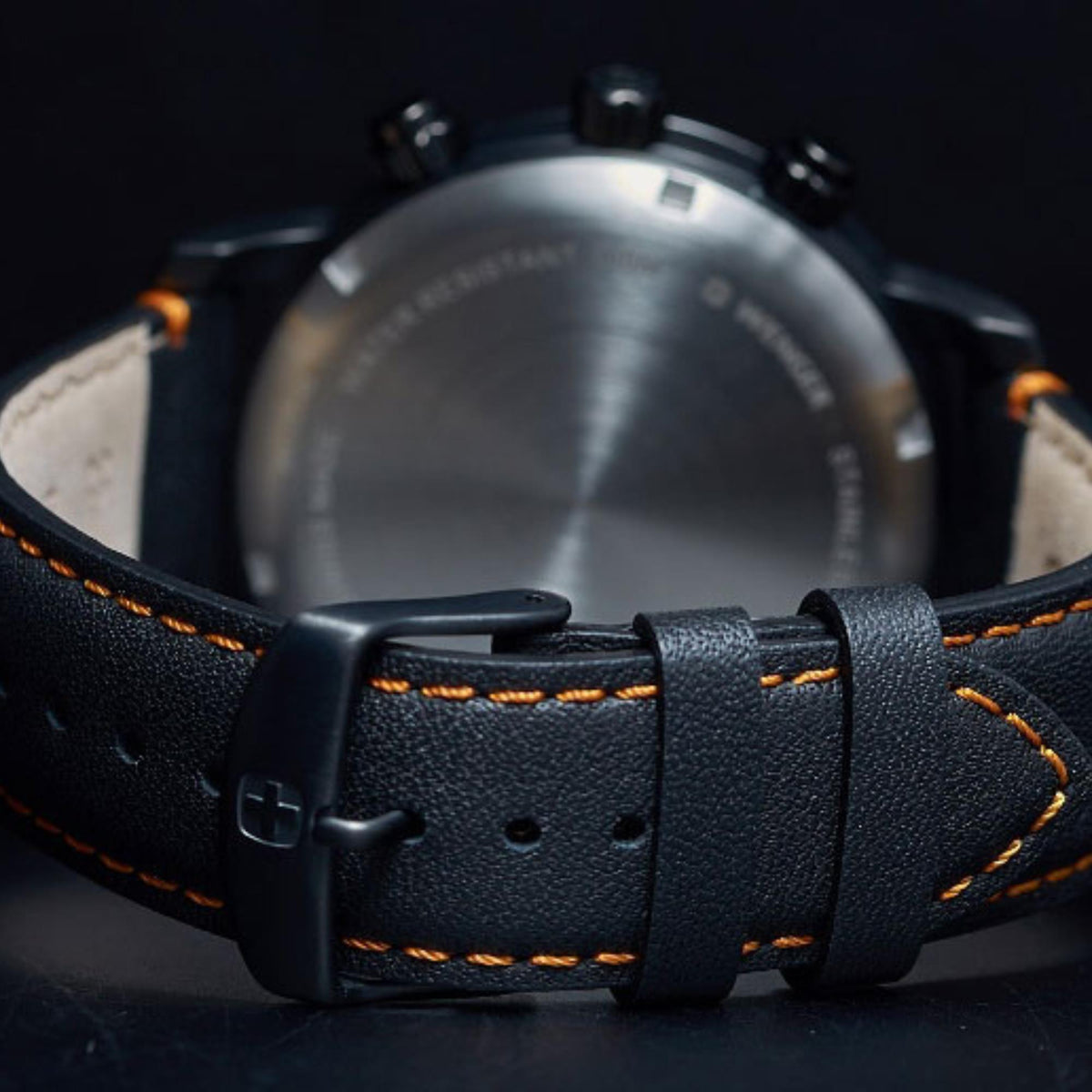 Black leather watch strap with buckle and orange stitching, Wenger case back view