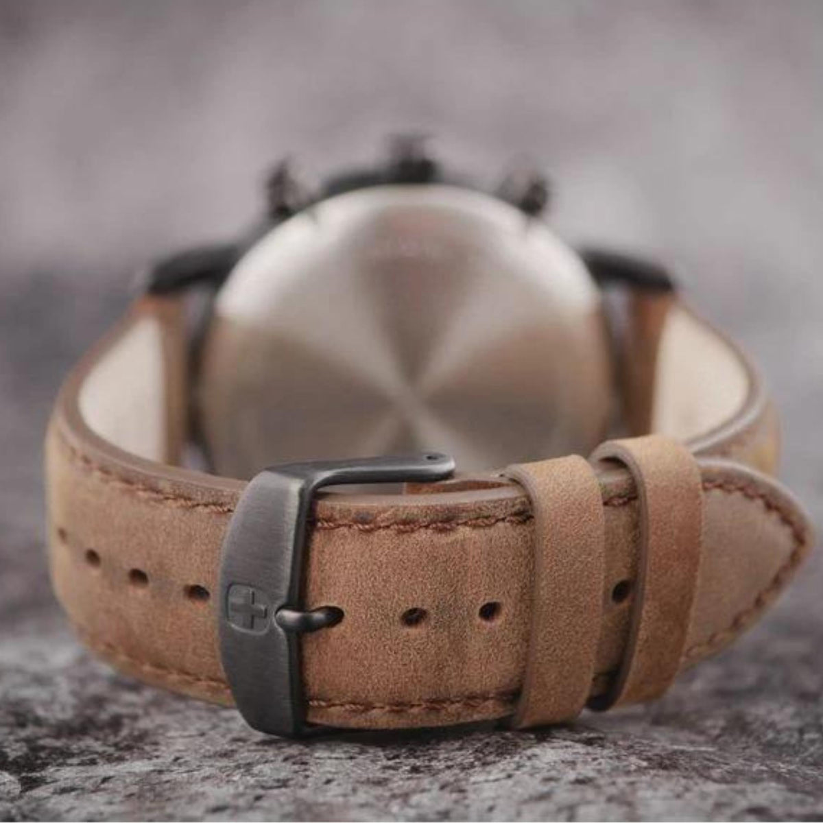 Brown leather watch strap with silver buckle and perforated keeper holes