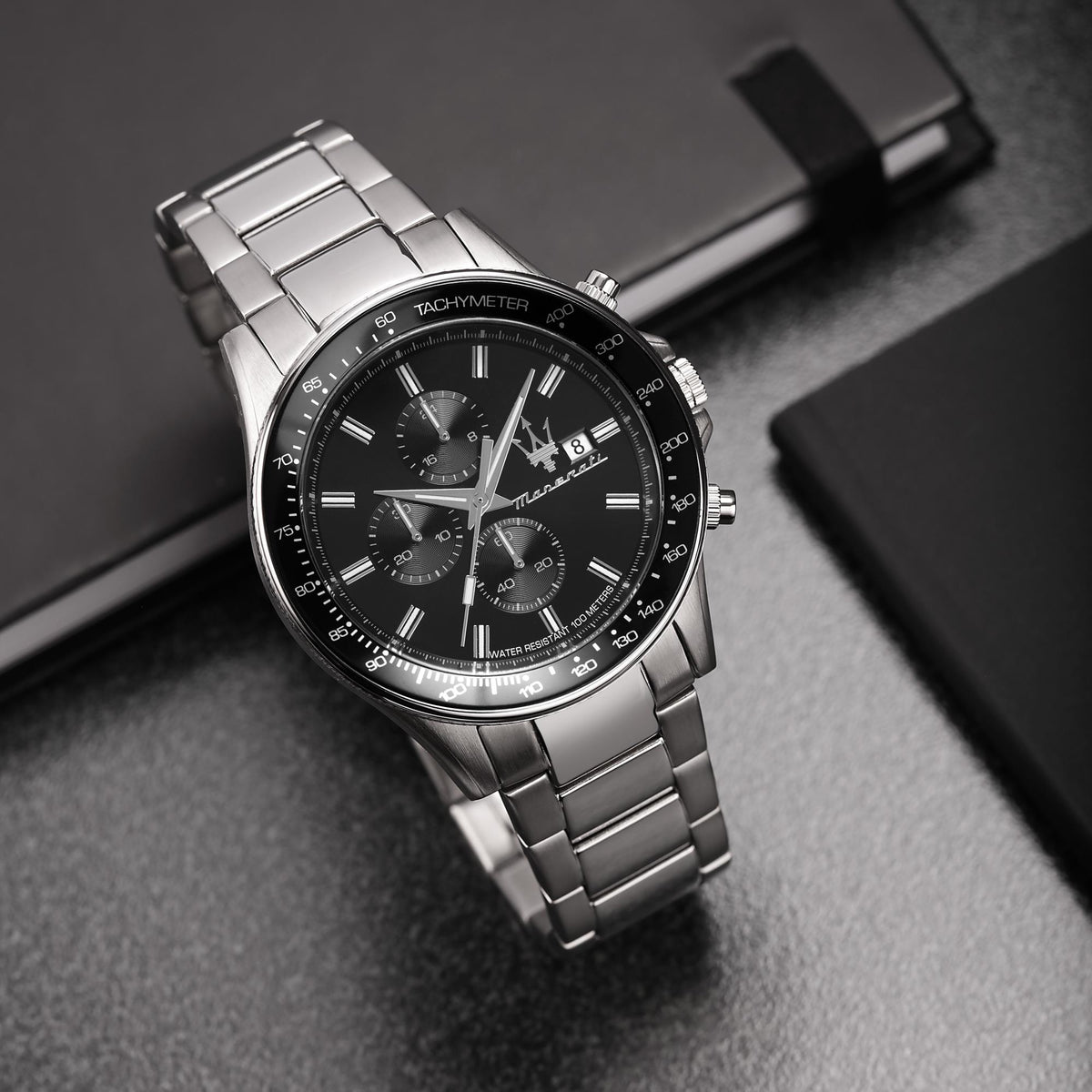 Men's steel chronograph watch with black dial and tachymeter bezel
