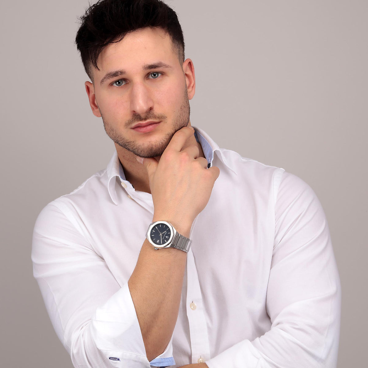 Men's steel quartz watch on wrist with blue dial and date window