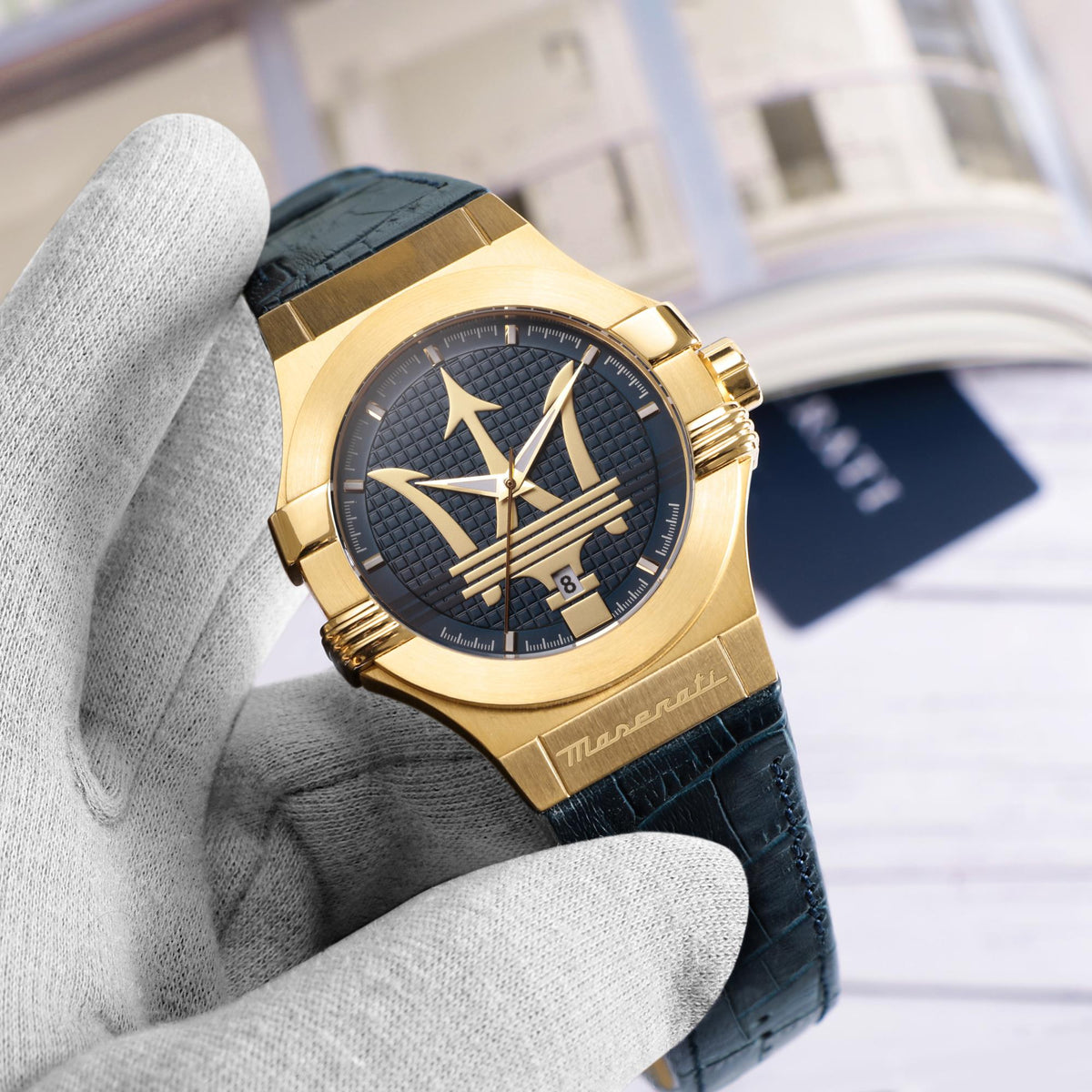 Men's Maserati quartz watch close-up with blue dial, blue leather strap, gold-tone case