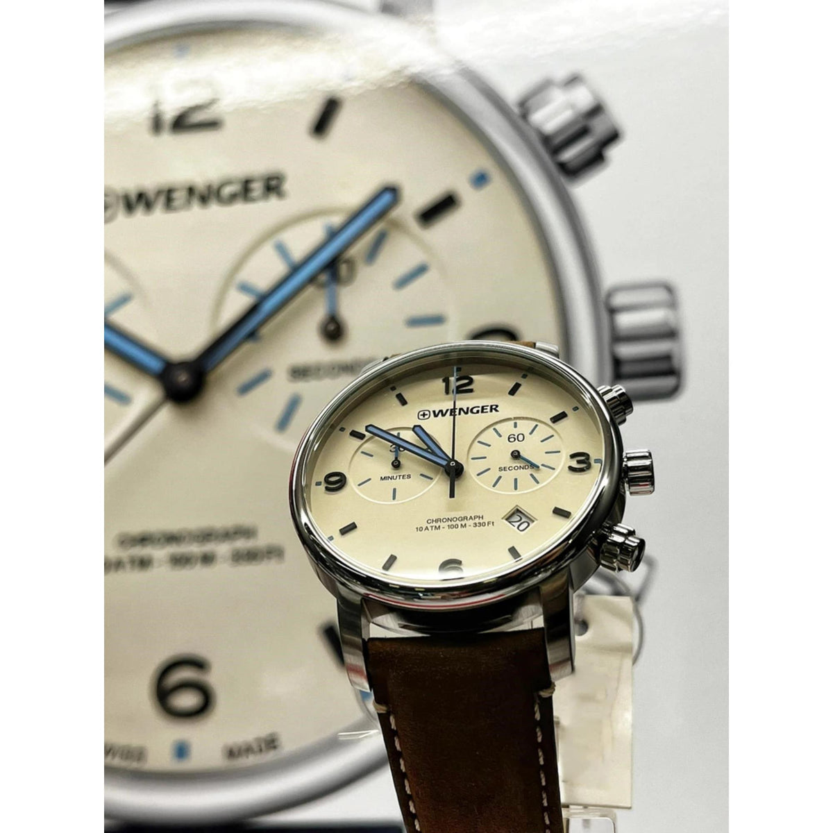 Wenger chronograph watch close-up: cream dial with blue hands and brown leather strap