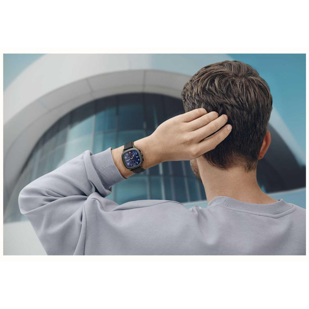 Men's sport watch on wrist, blue dial and black silicone strap visible.