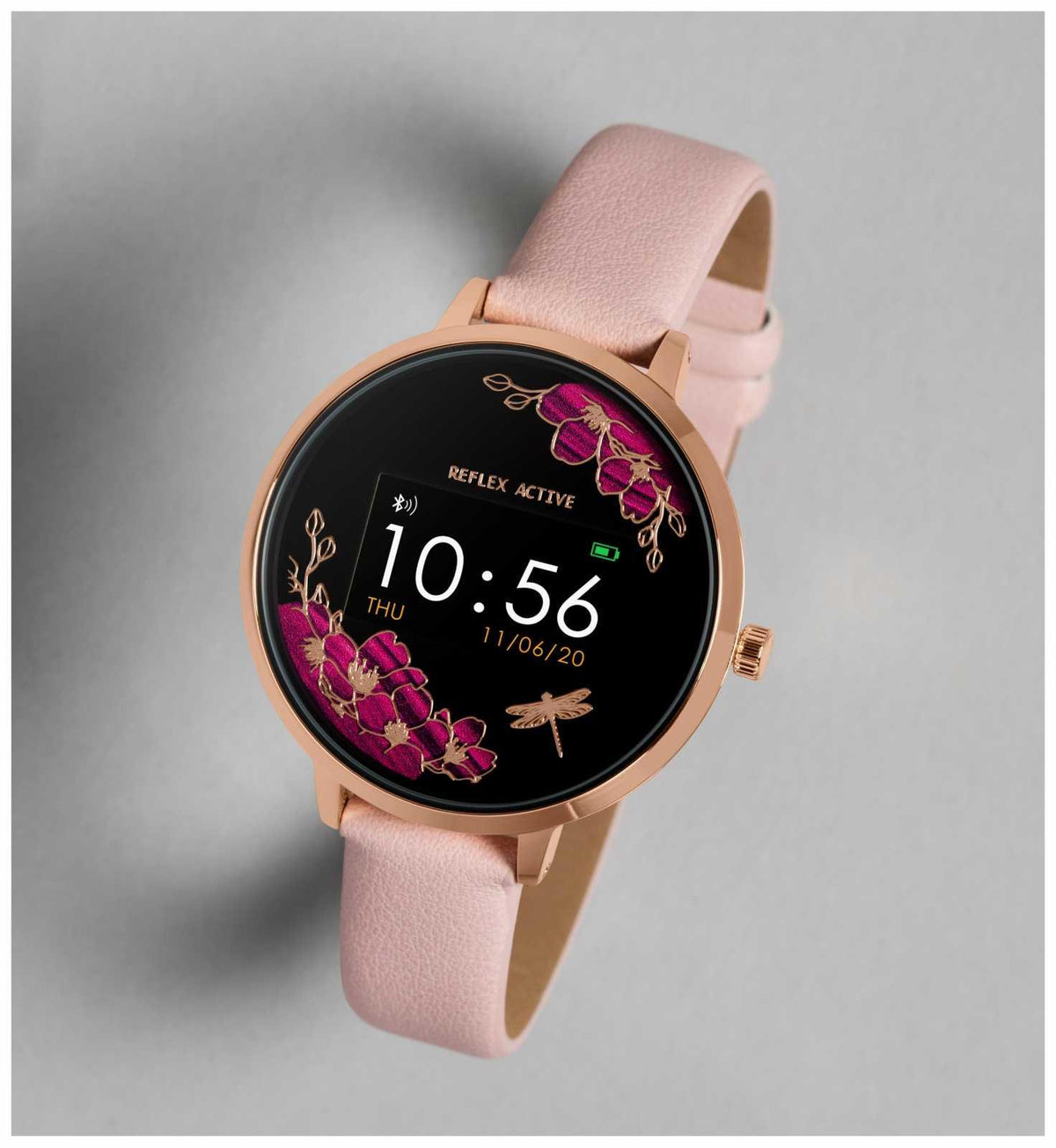 Rose-gold bezel smartwatch with pink faux leather strap and black floral display