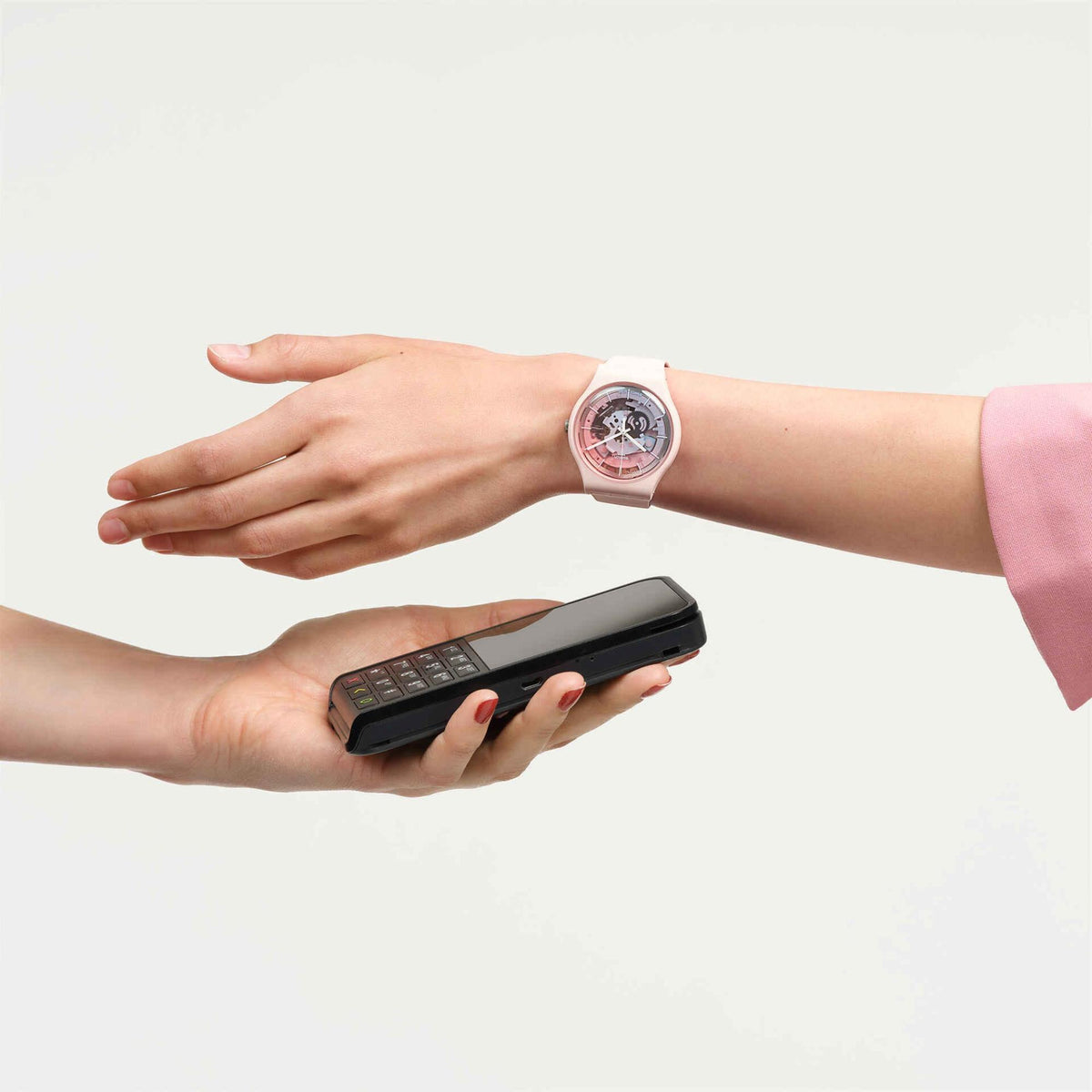 Unisex pink silicone strap watch on wrist with see-through skeleton dial