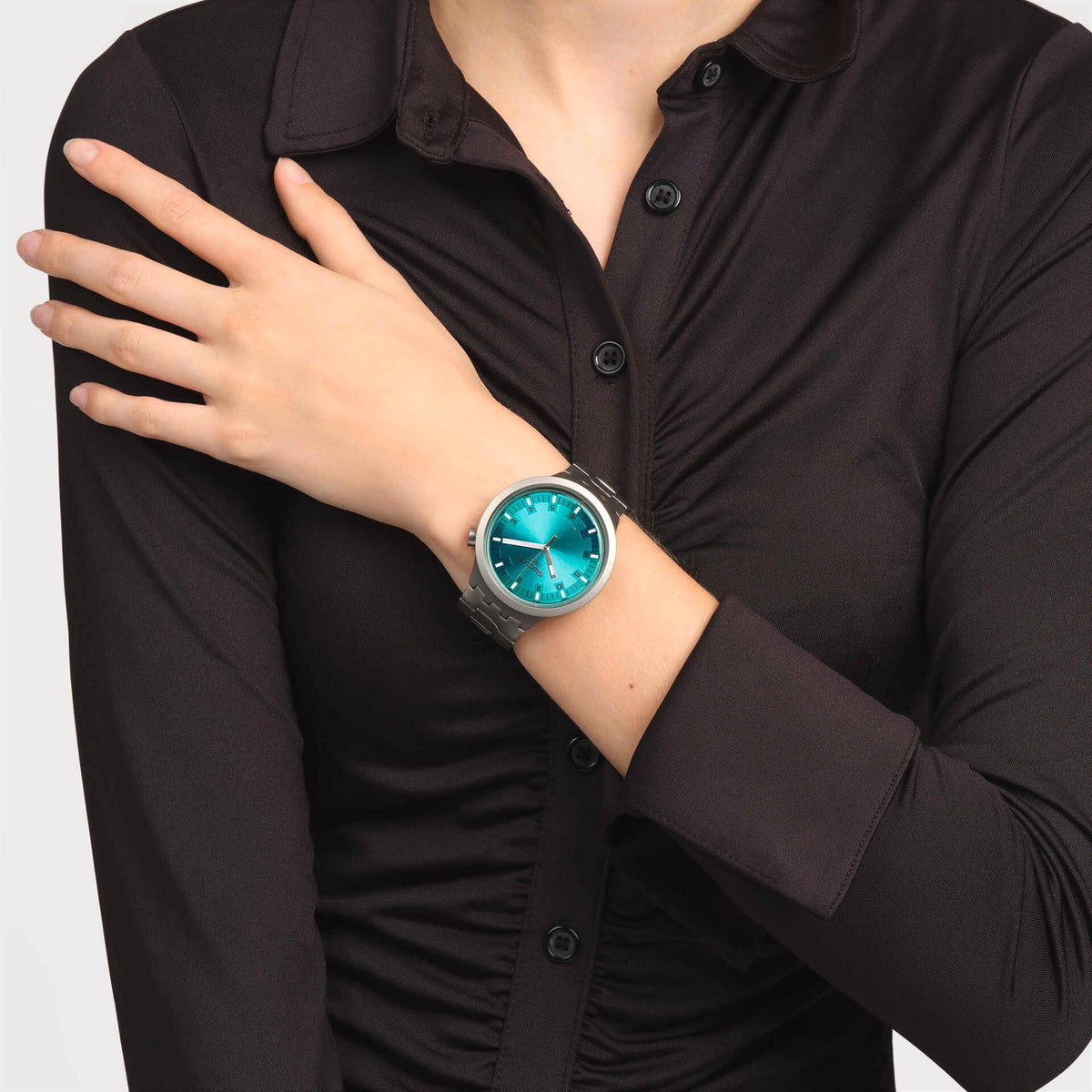 Unisex wristwatch with aqua shimmer dial and steel link bracelet, worn on wrist