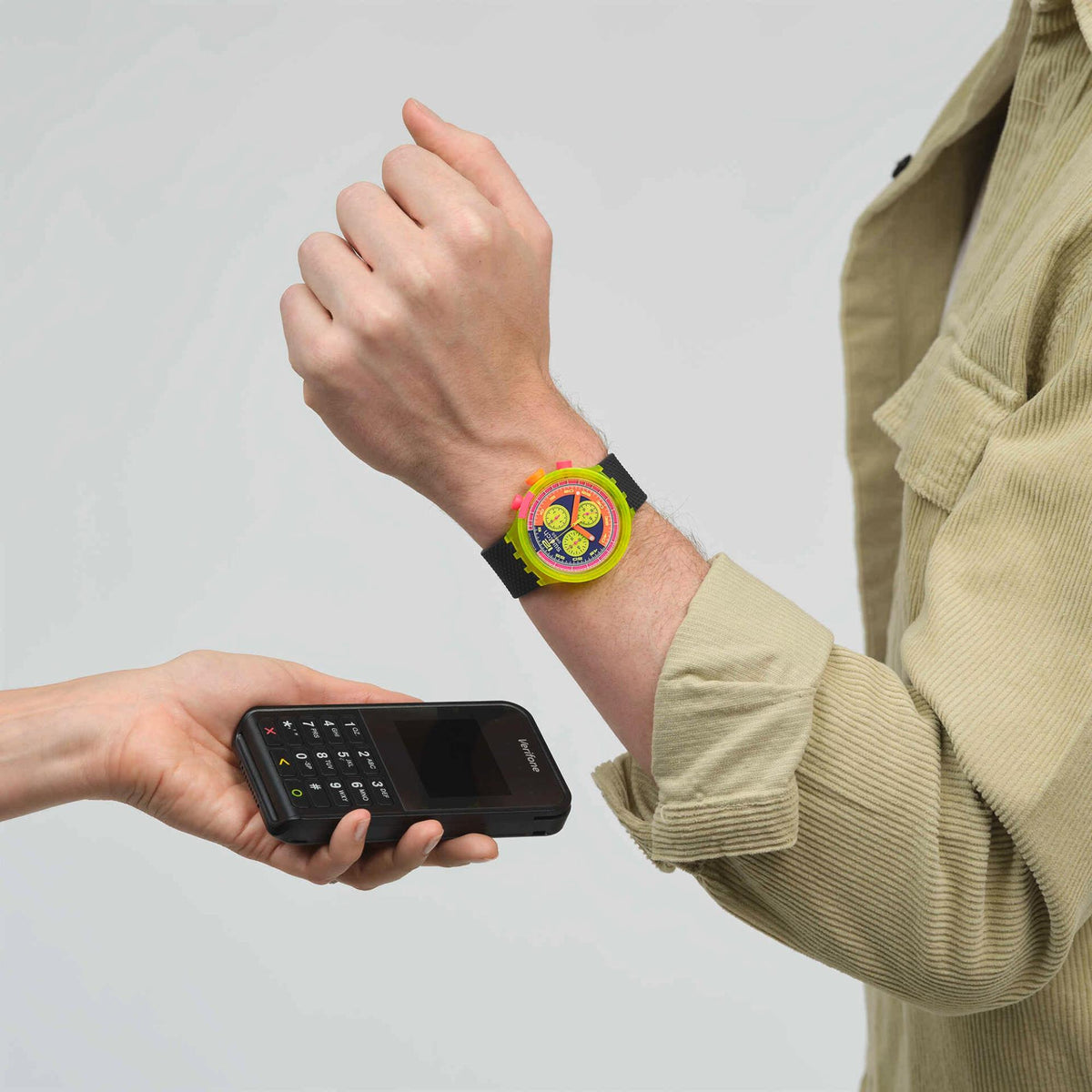 Neon multicolor dial quartz watch on wrist with dark blue textured silicone strap