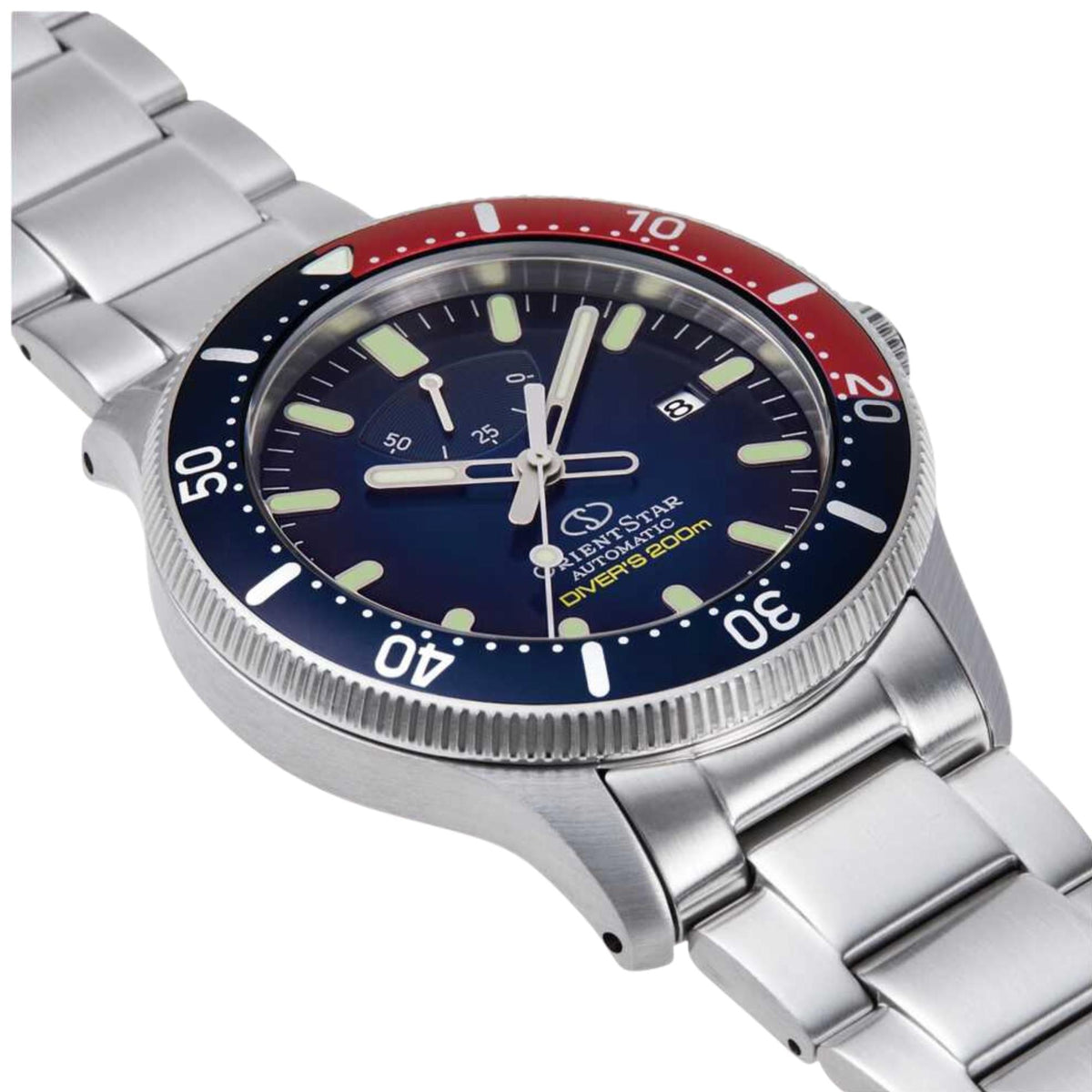 Men's automatic dive watch close-up: blue dial, red bezel ring, steel bracelet and crown