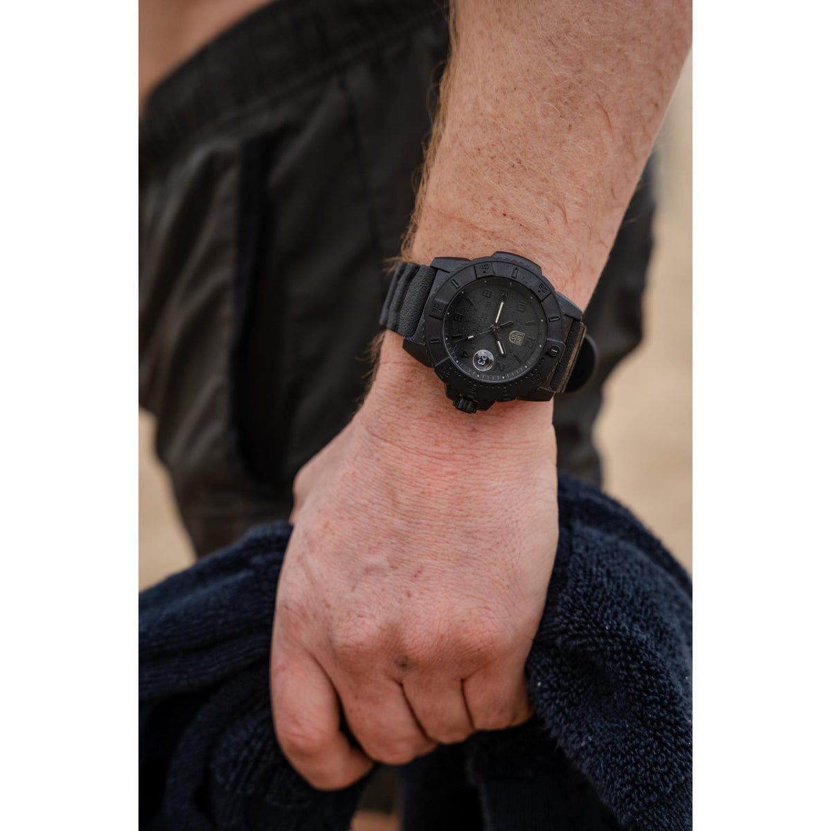 Men's Luminox Navy SEAL 45mm watch on wrist with black rubber strap and date window