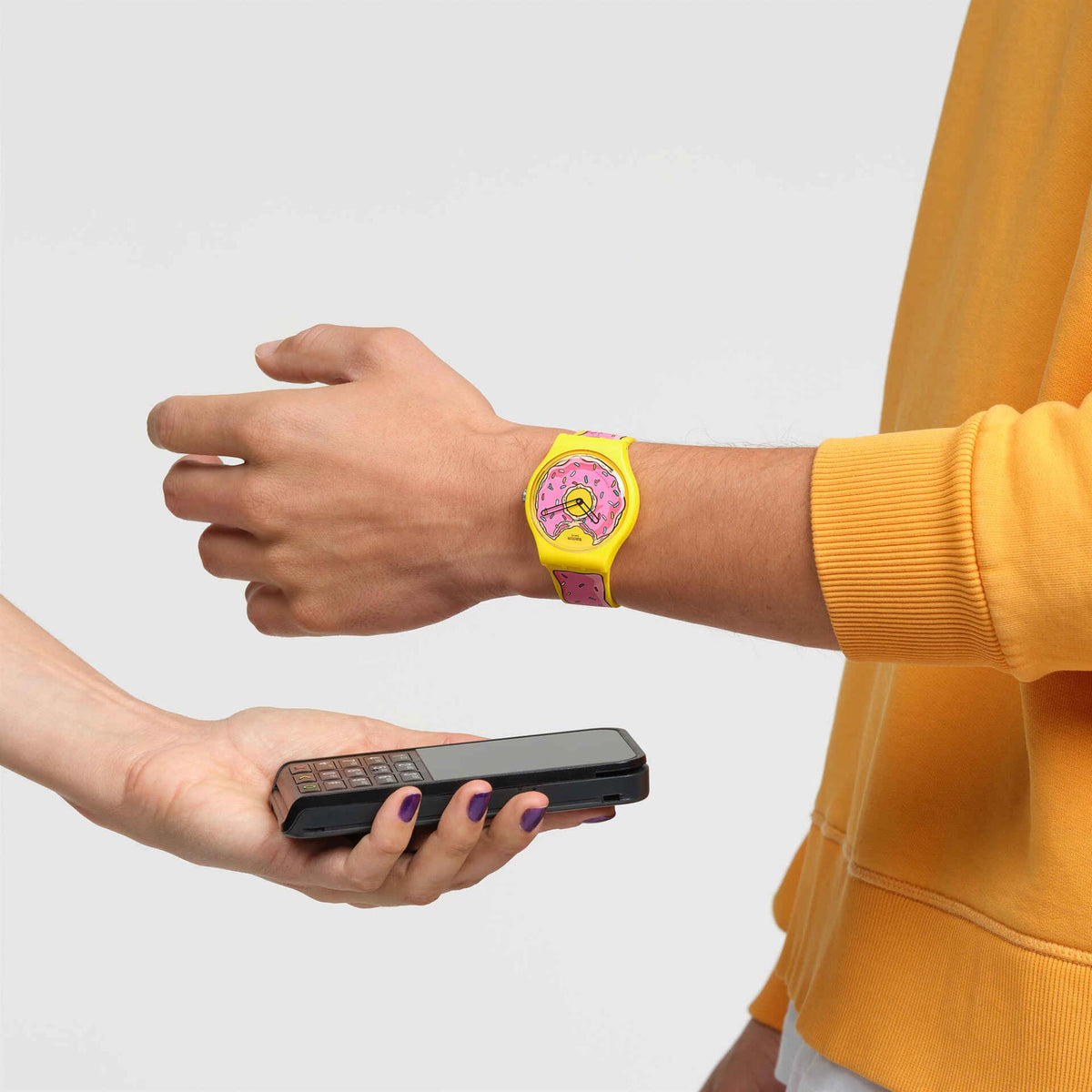 Unisex watch on wrist: yellow silicone strap with pink cartoon donut dial