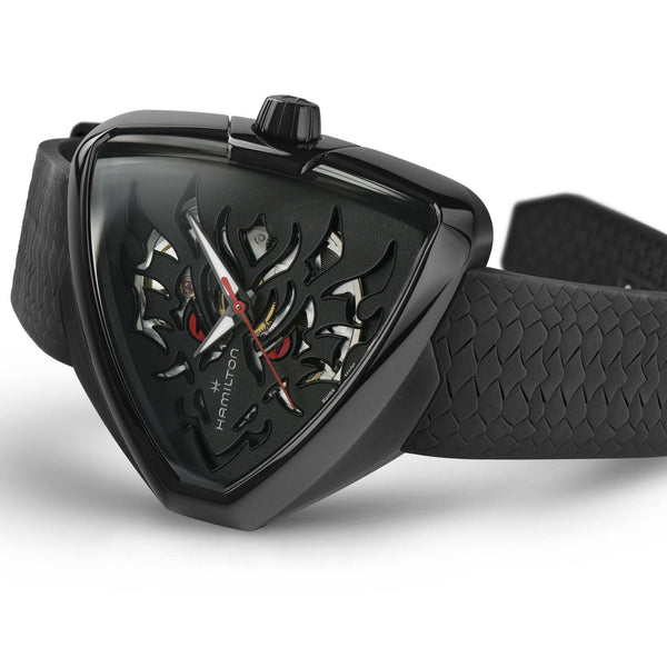 Black skeleton dial watch with black rubber strap and detailed crown