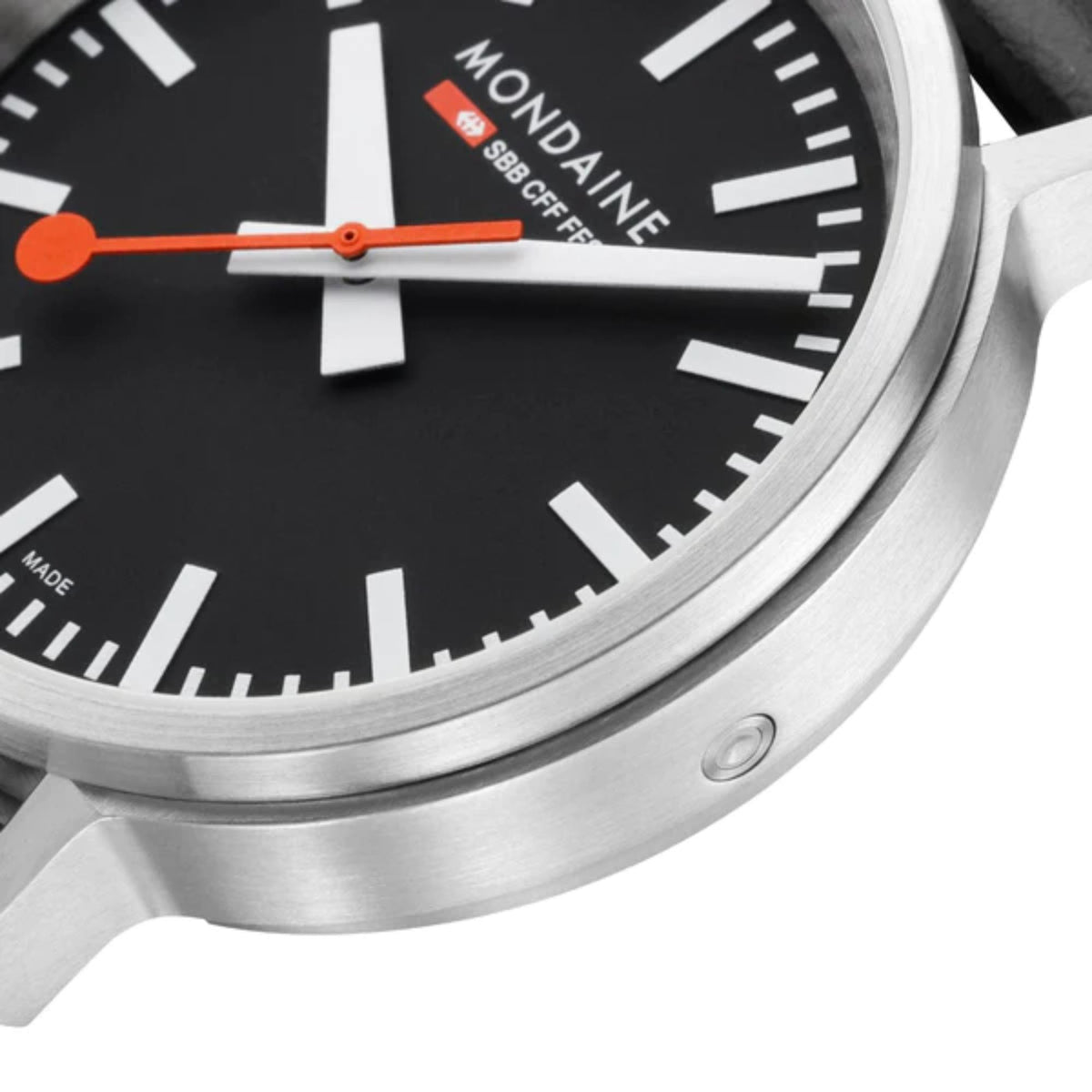 Mondaine stop2go black dial close-up with orange hands and silver bezel