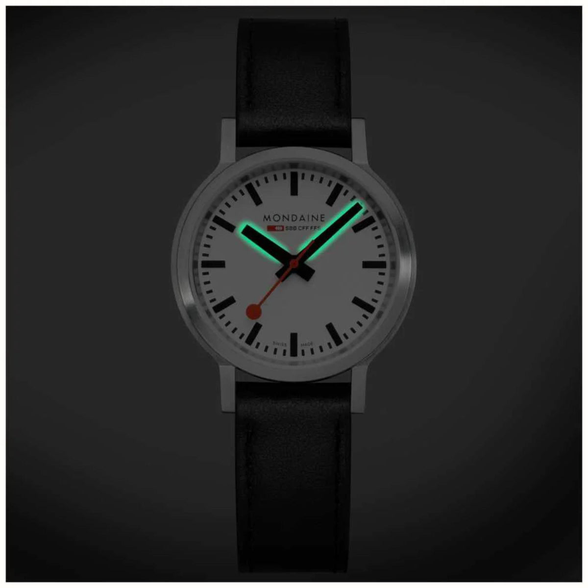 Mondaine quartz watch with black leather strap, white dial, green-accented hands