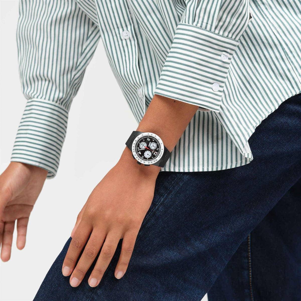 Black silicone quartz watch on wrist, black dial with red second hand and three subdials
