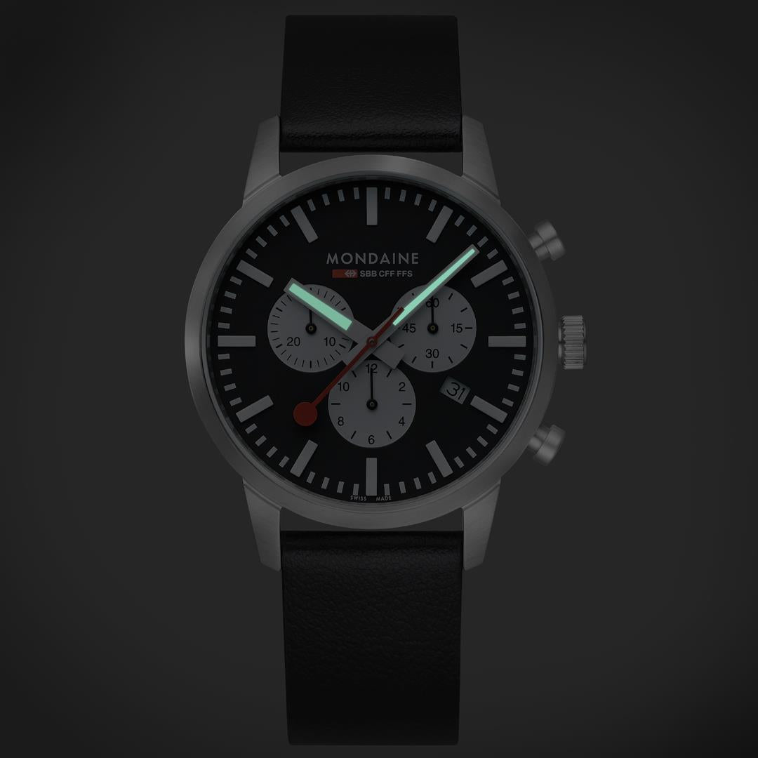 Mondaine Neo MSD.41420.LBV front shot highlighting luminous hands in dark setup