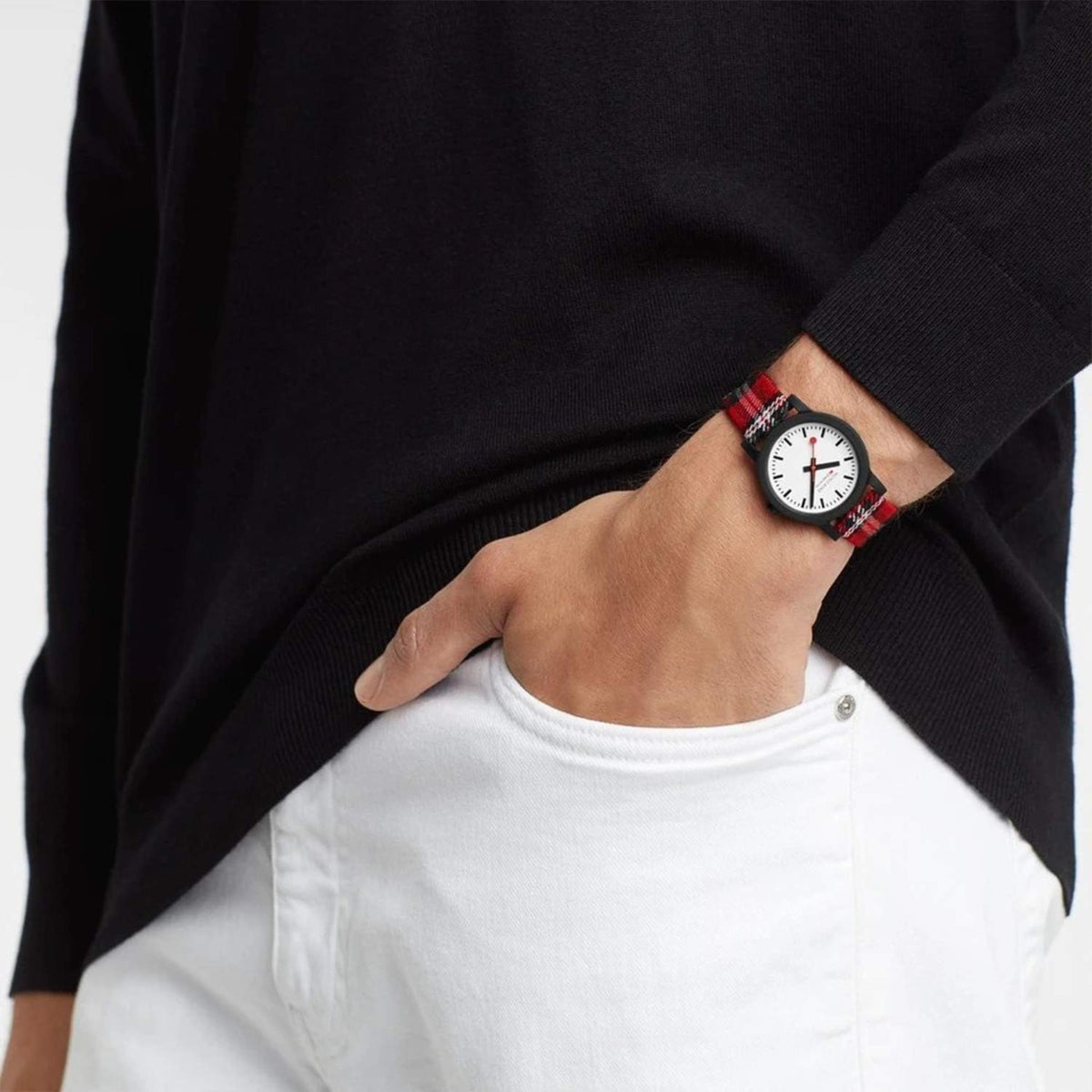 Quartz watch on wrist with white dial, black case, and red-and-black tartan strap