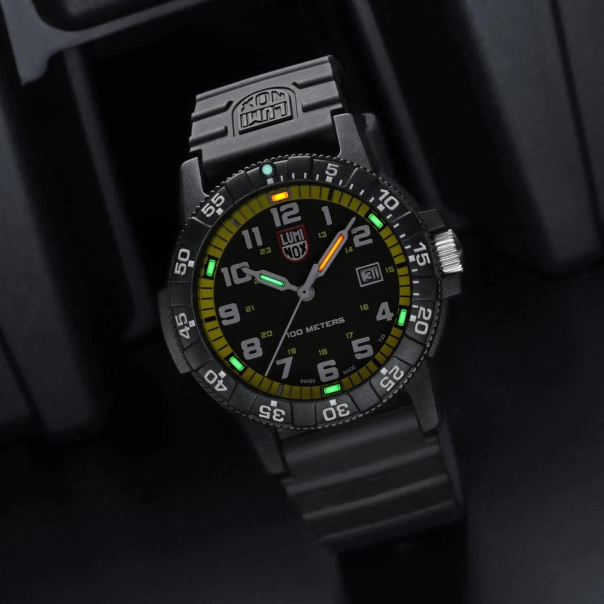 Black Luminox dive watch with yellow bezel and glowing accents, black silicone strap