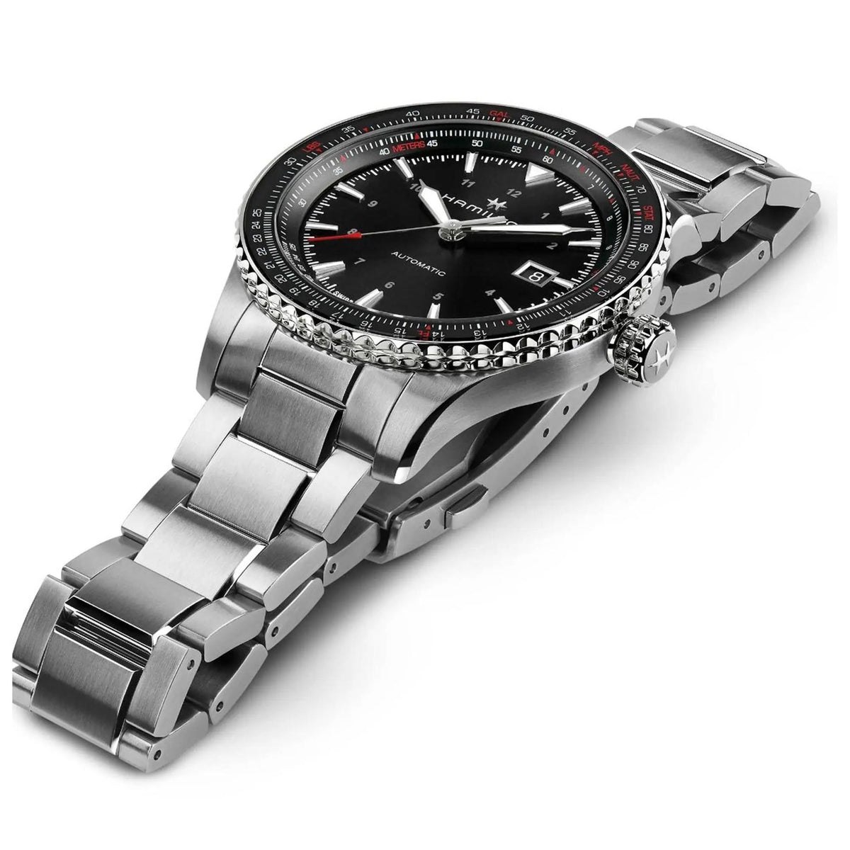 Side angle view of the Hamilton Khaki Aviation watch resting flat to show the textured grip of the bezel and the profile of the steel bracelet