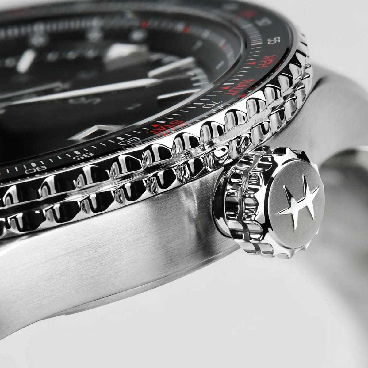 Close-up shot focusing on the crown engraved with the brand logo and the polished ridges of bezel