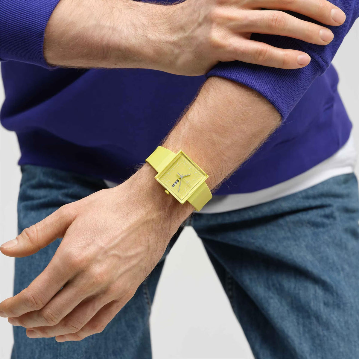 Swatch WHAT IF…LEMON? SO34J700 unisex watch on a persons wrist with blue sweatshirt