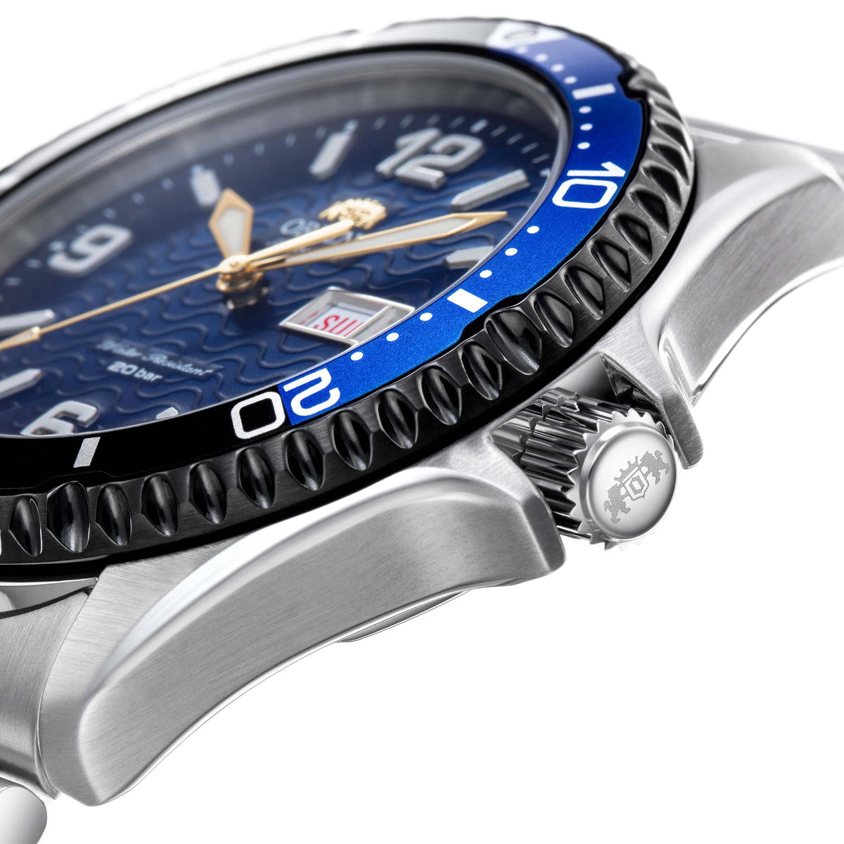 Stainless steel watch with blue bezel insert and crown detail beside brushed bracelet